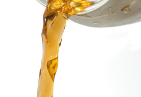 Closeup of a pouring sodas against a white background